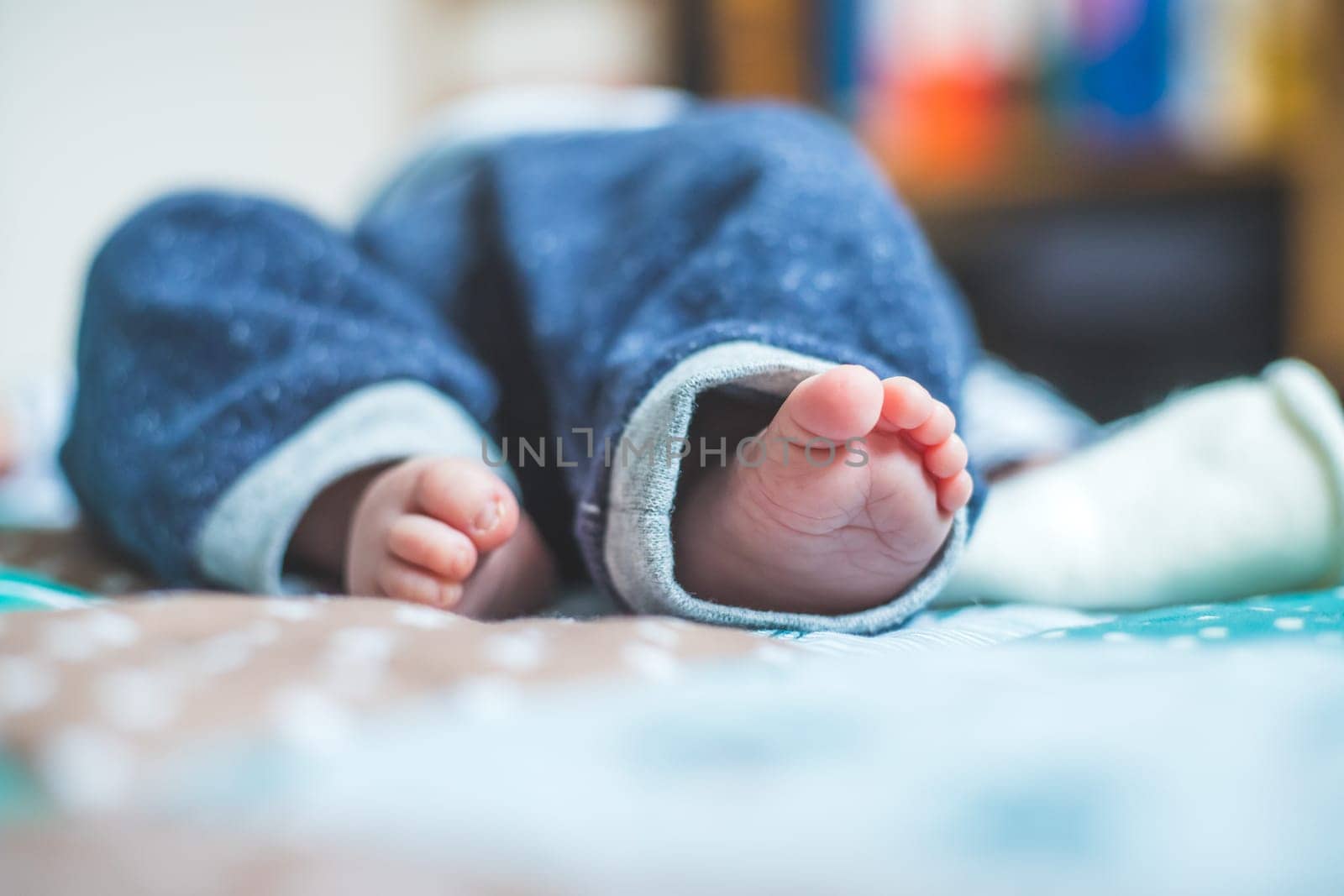 Close up of newborn baby feet on baby blanket