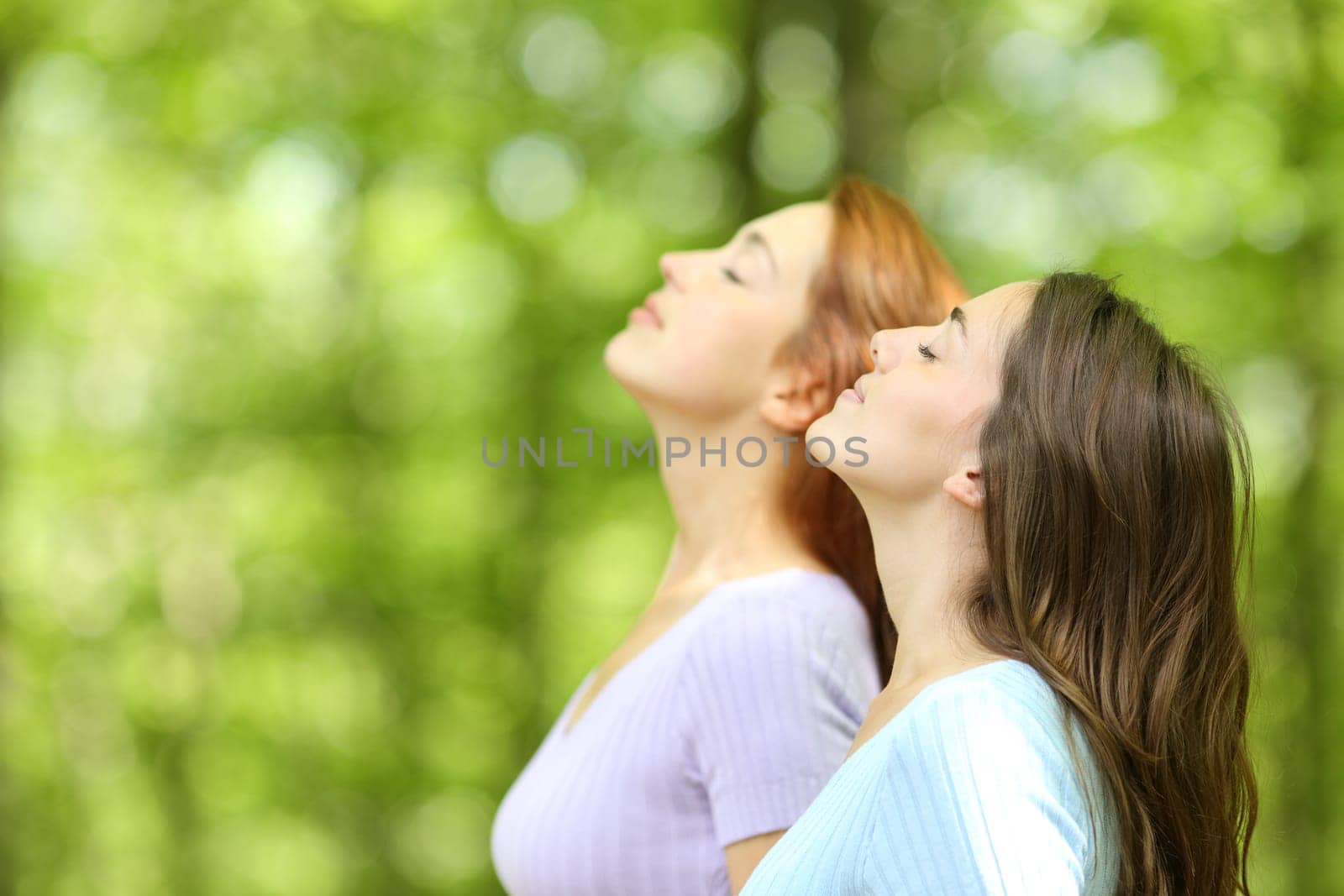 Two women breathing fresh air in a forest or park