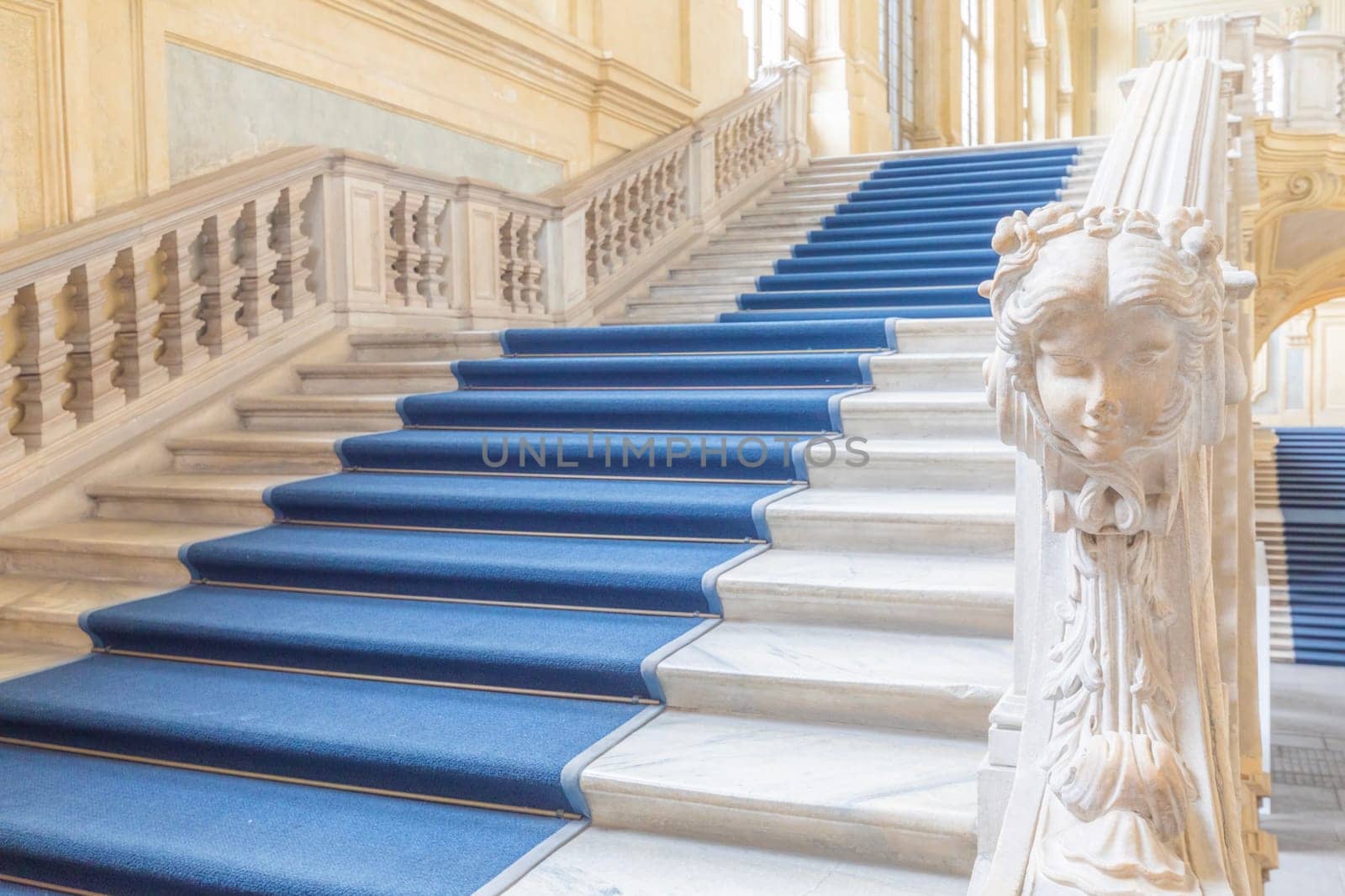TURIN, ITALY - CIRCA JUNE 2021: The most beautiful Baroque staircase of Europe located in Madama Palace (Palazzo Madama). Interior with luxury marbles, windows and corridors.