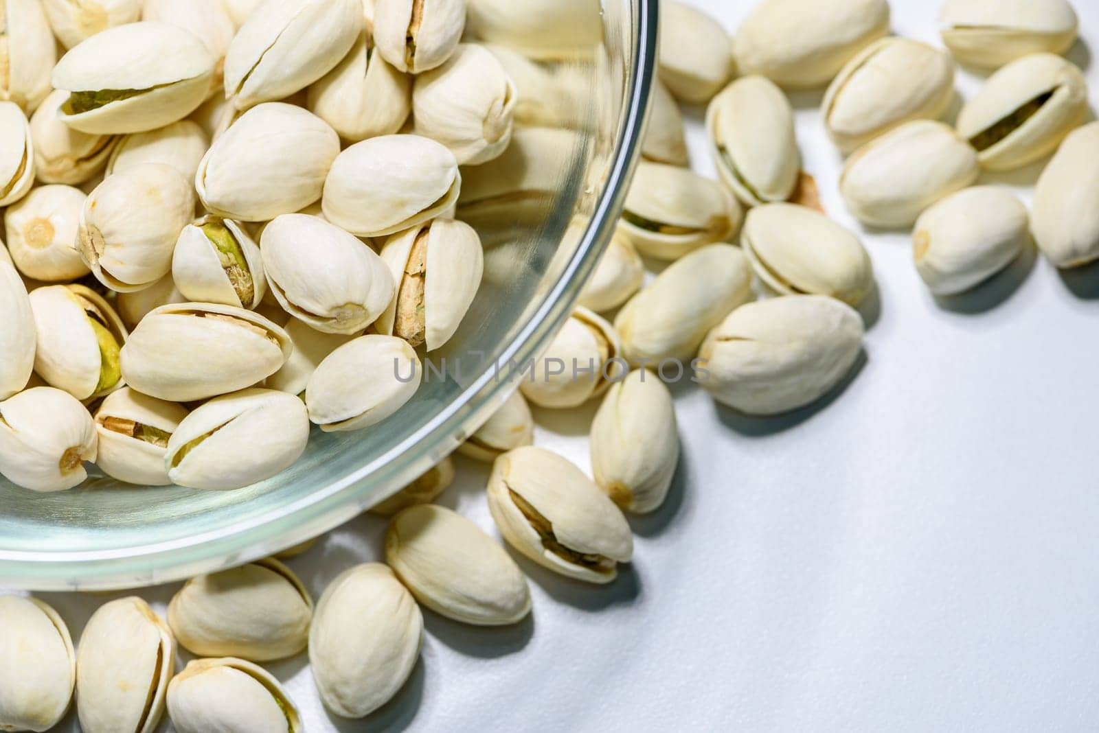 Close-up top view a pile of nut it has a white nutshell dry and hard of Pistachio, Pistache or Pistacia vera in a bowl food delicious salty snack copy space for background