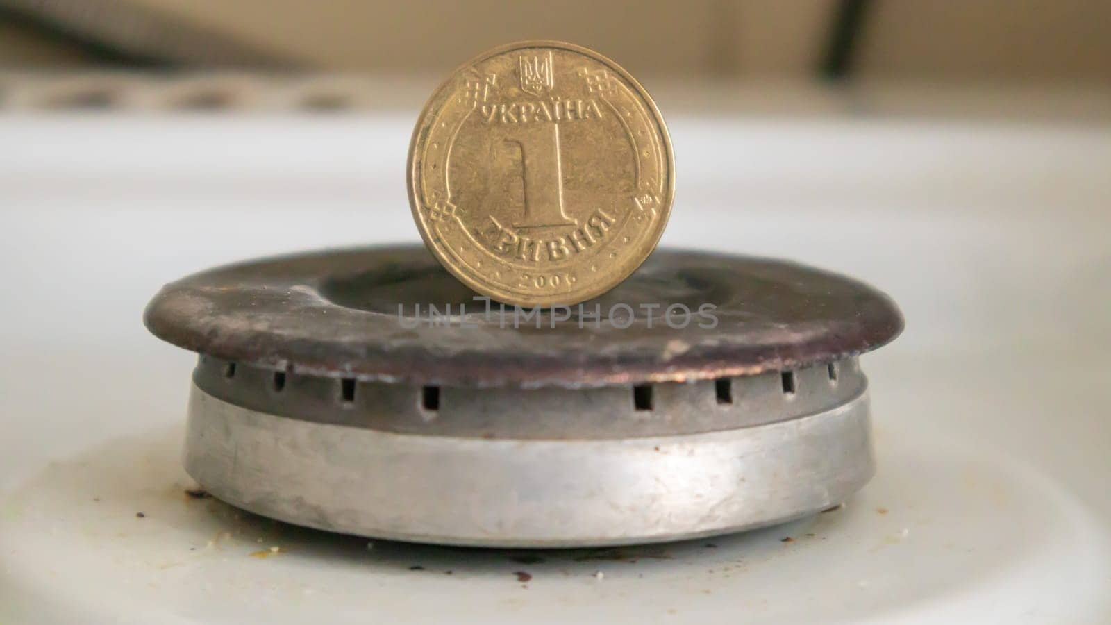 Ukrainian hryvnia on a gas water heater without fire. Gas stove with money. Conceptual image of a rising tariff for violence. Natural gas saving concept at home, high gas prices