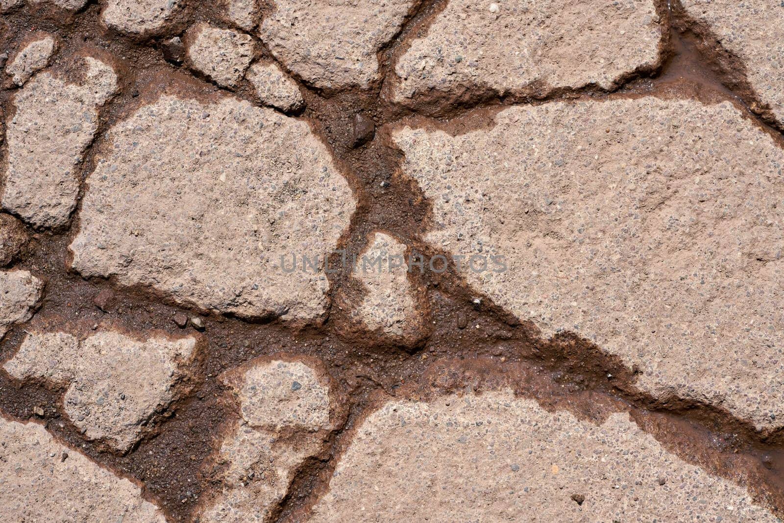 Cracks in the surface of the pavement of a weathered road