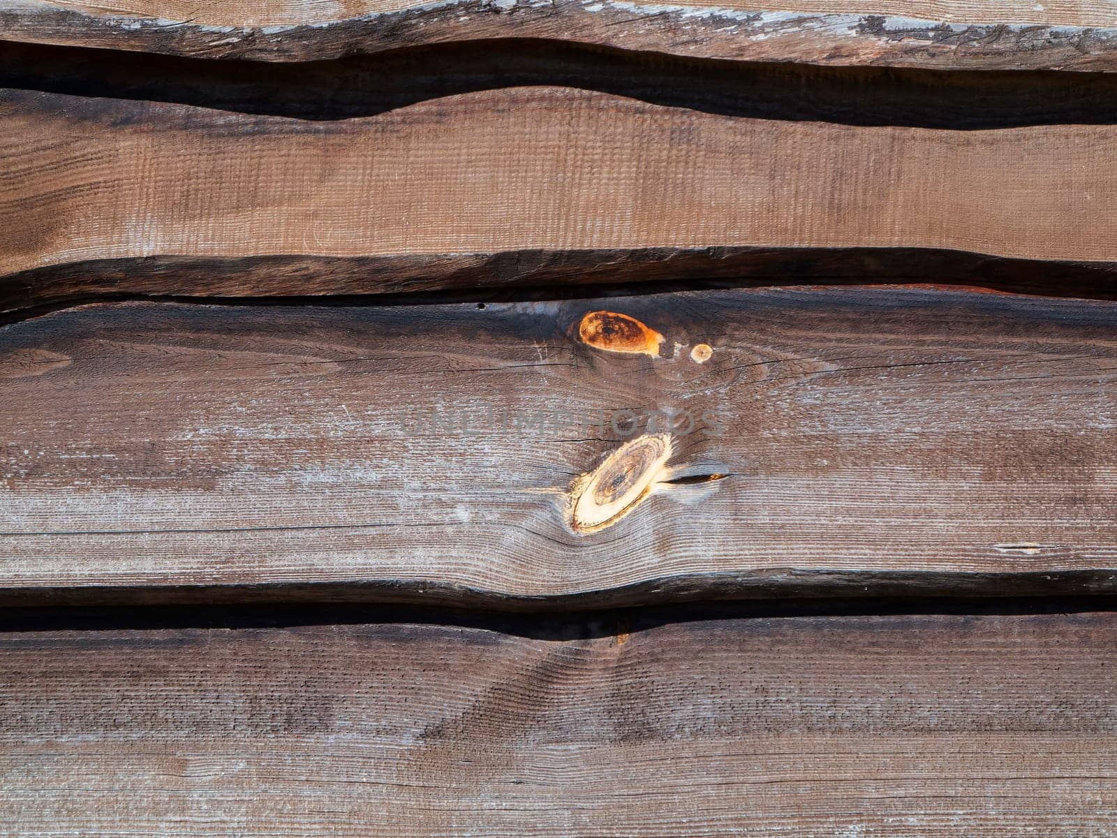 Format-filling view of horizontally overlapping built-in and untrimmed boards in the outdoor area.
