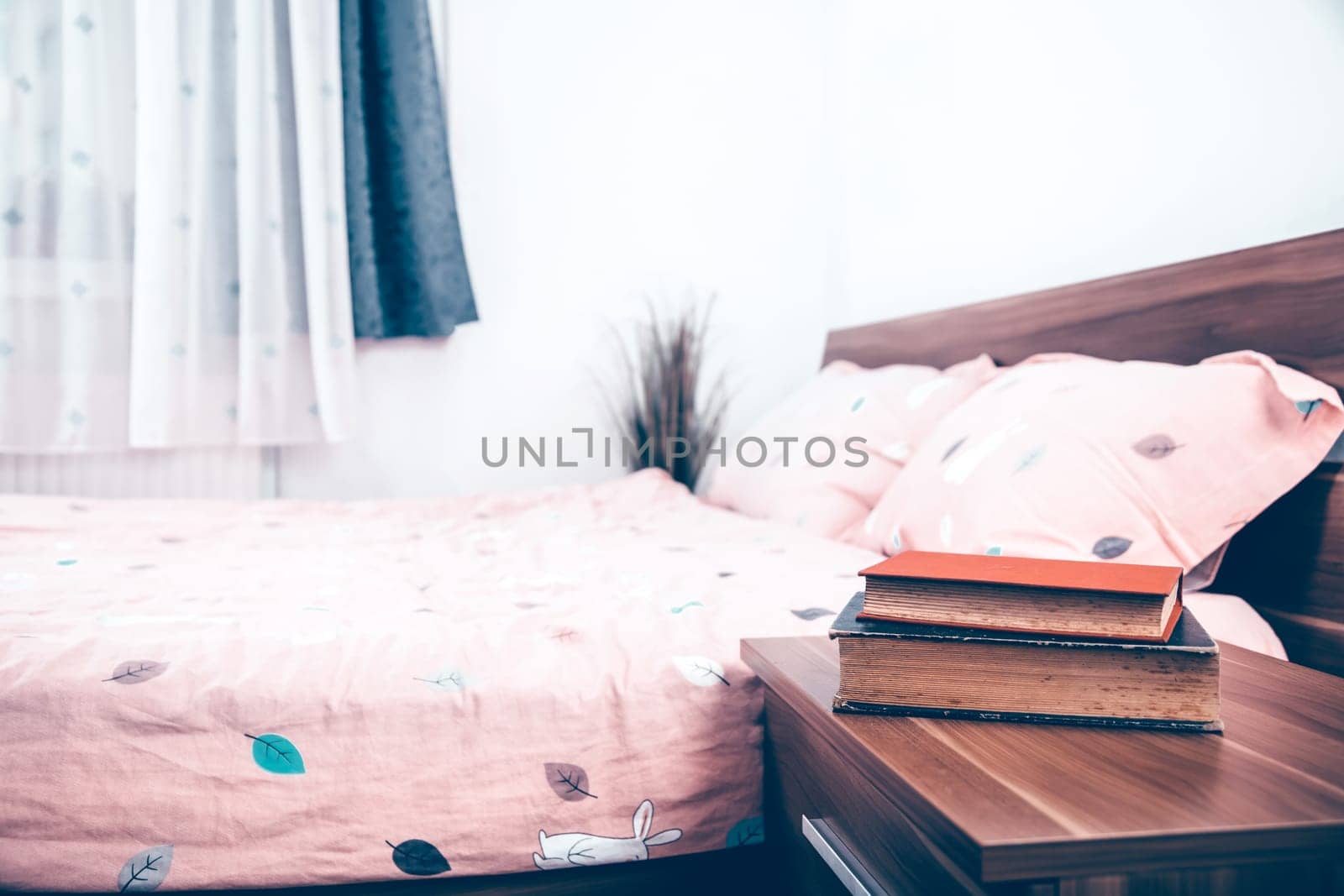 Book on a nightstand table in the bedroom on a sunny morning