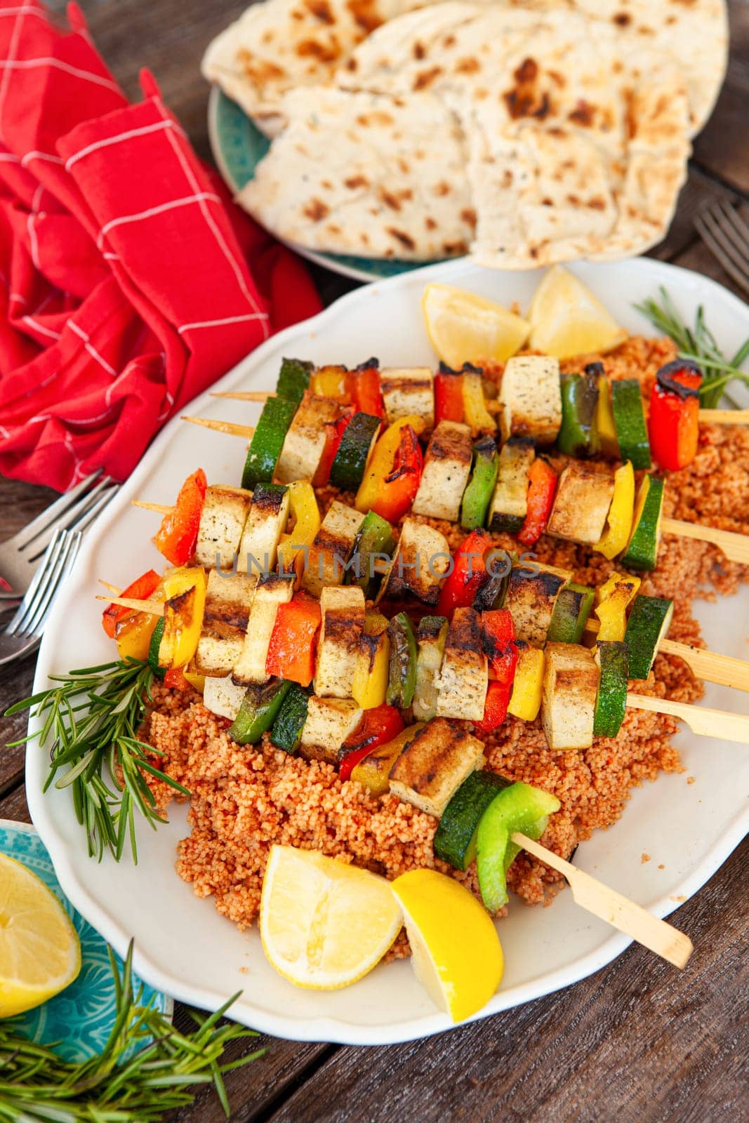 Grilled vegetable skewers with soy on tomato couscous