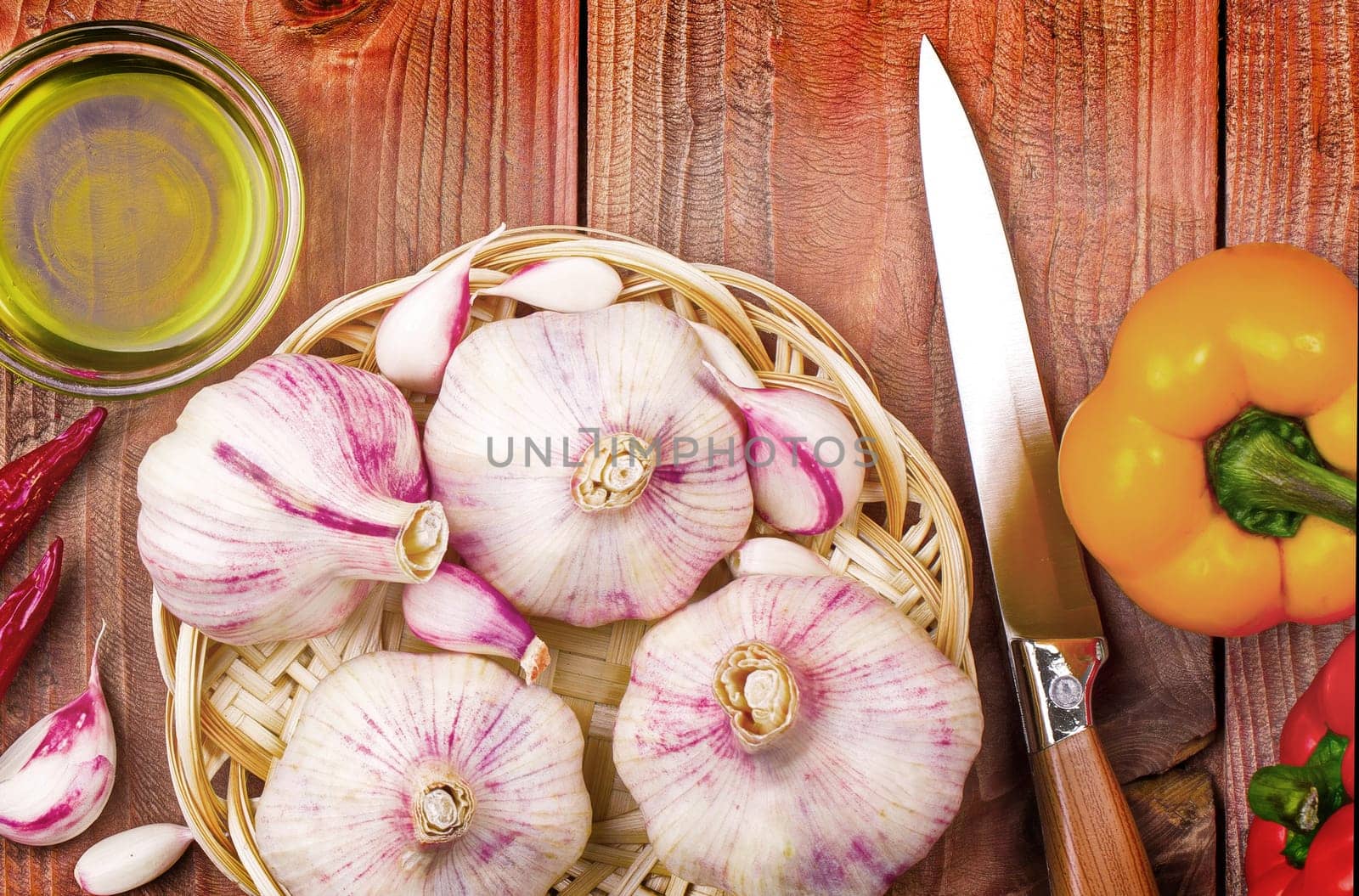 The Culinary background garlic, pepper on a wooden table