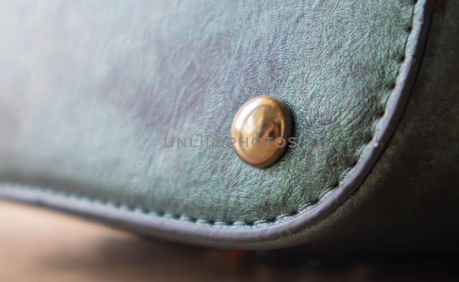 Detail of a fashionable leather bag close up. Fashion concept. Details of sewing threads, macro photography. Stylish female accessory