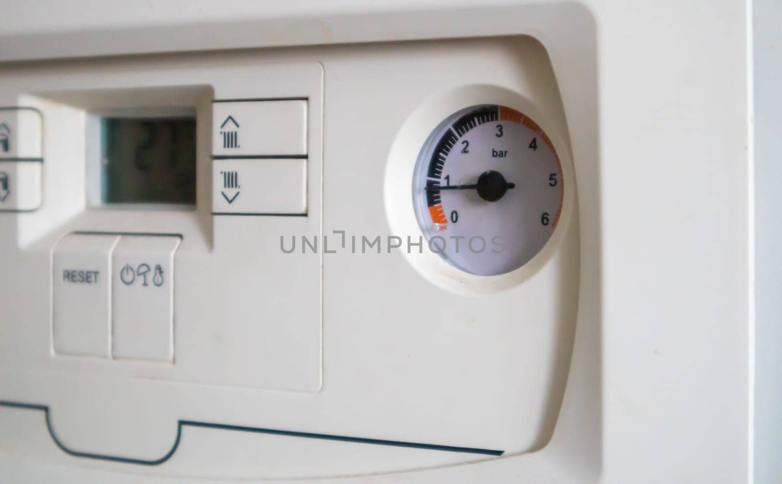 Internal control of a gas double-circuit boiler with a pressure and temperature sensor in the home heating system, close. Energy saving and image efficient home concept. Selective focus