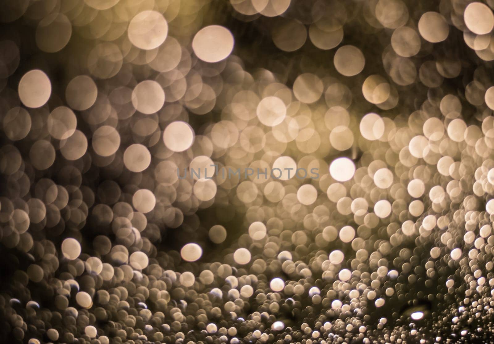 Abstract blurred dark brown light from water drop at the windscreen bokeh background