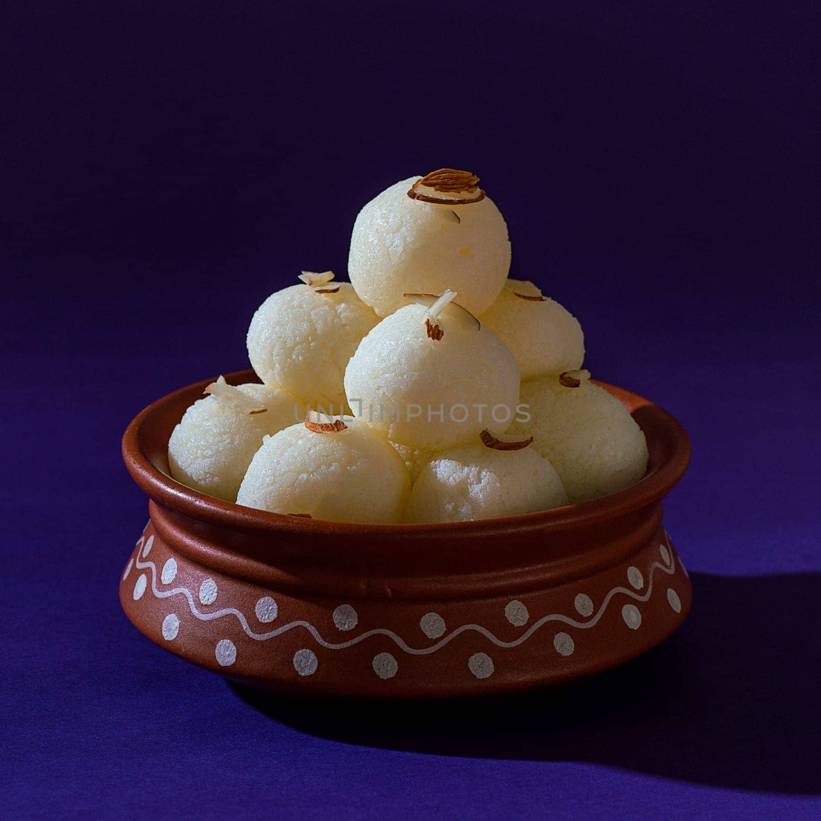 ndian Sweet or Dessert - Rasgulla in clay pot