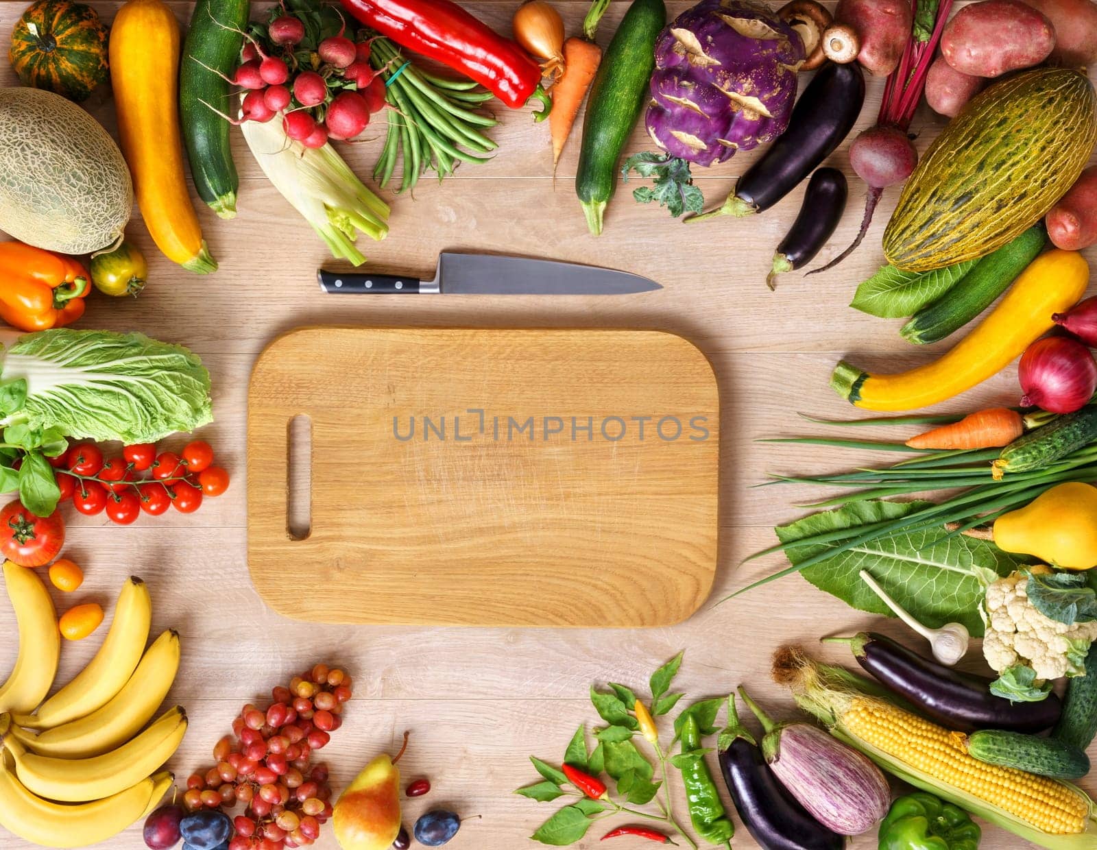 Healthy food background and Copy space / studio photography of wooden board surrounded by fresh vegetables on wooden table