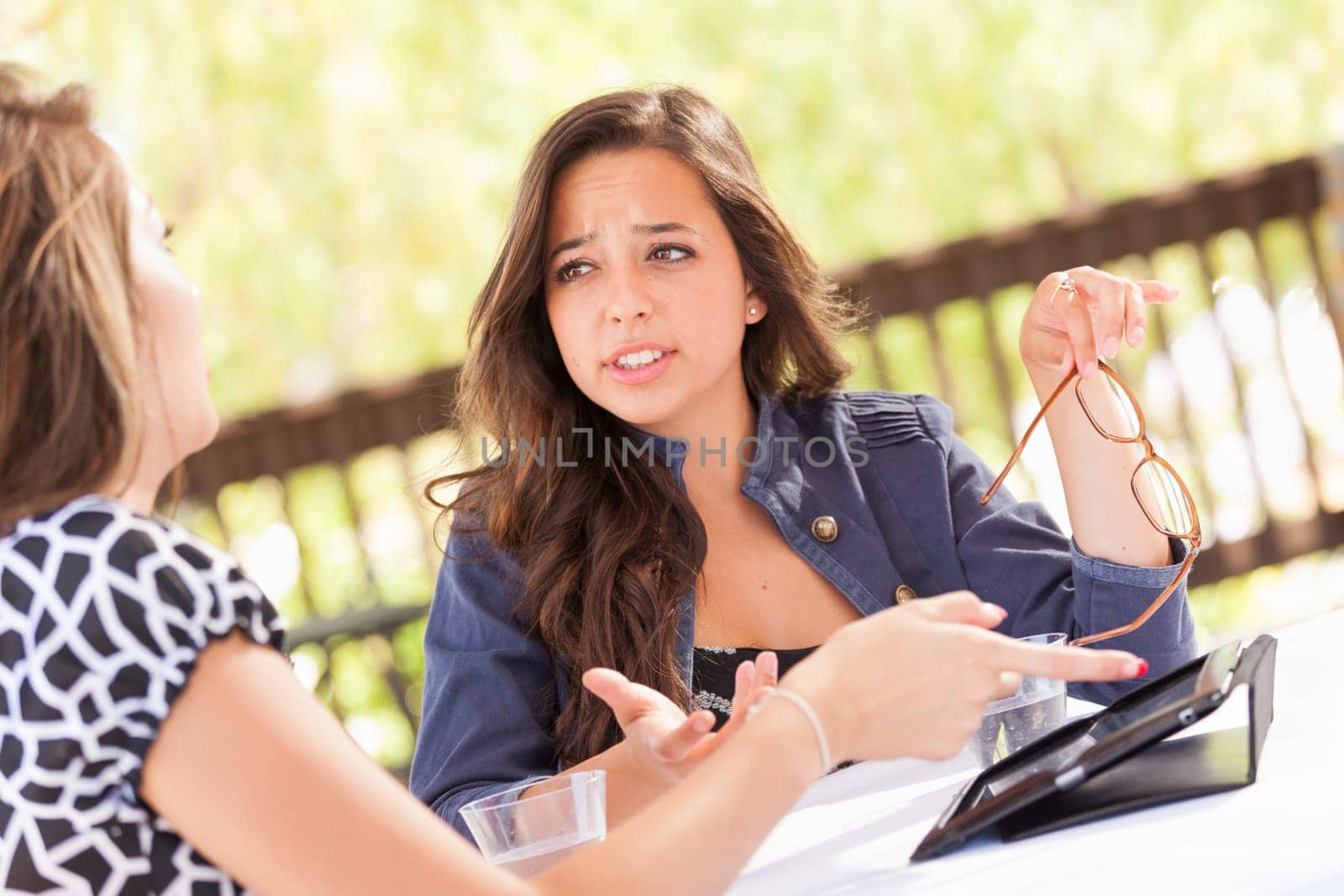 Expressive Young Adult Girlfriends Using Their Computer Electronics Outdoors