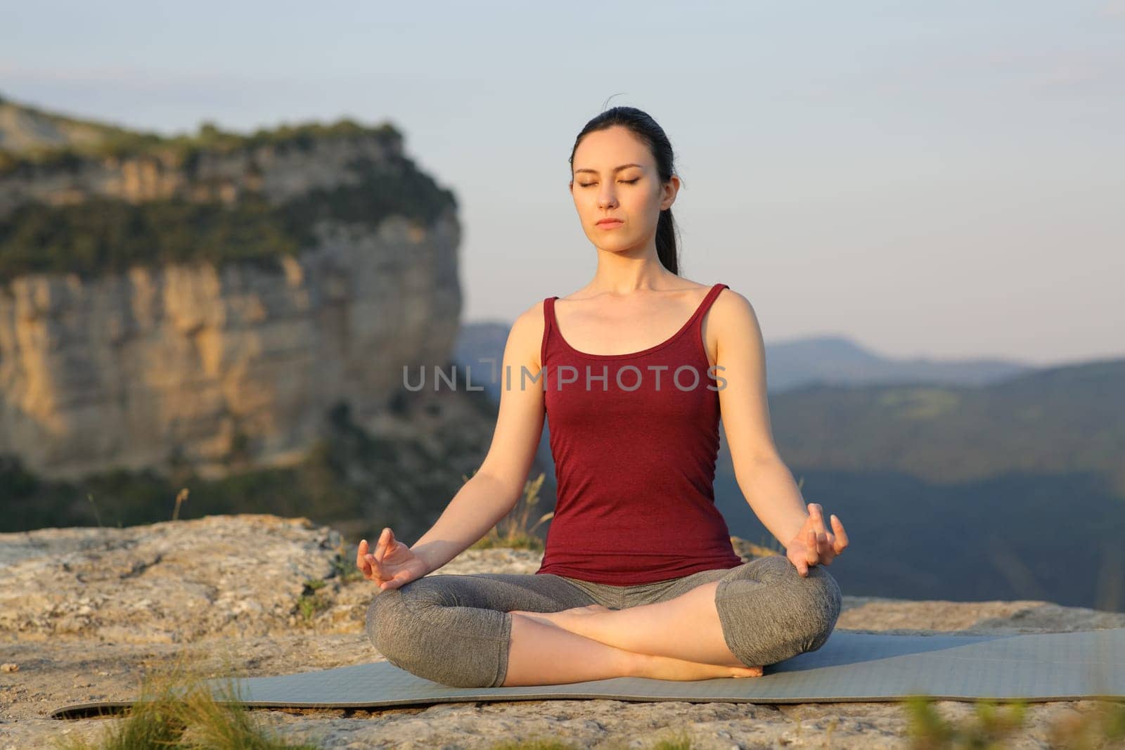 Mixed race woman doing yoga exercise in the mountain