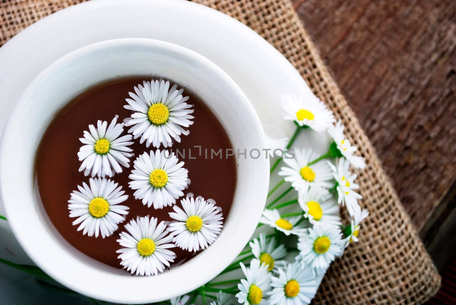 Cup of natural tea on wooden background