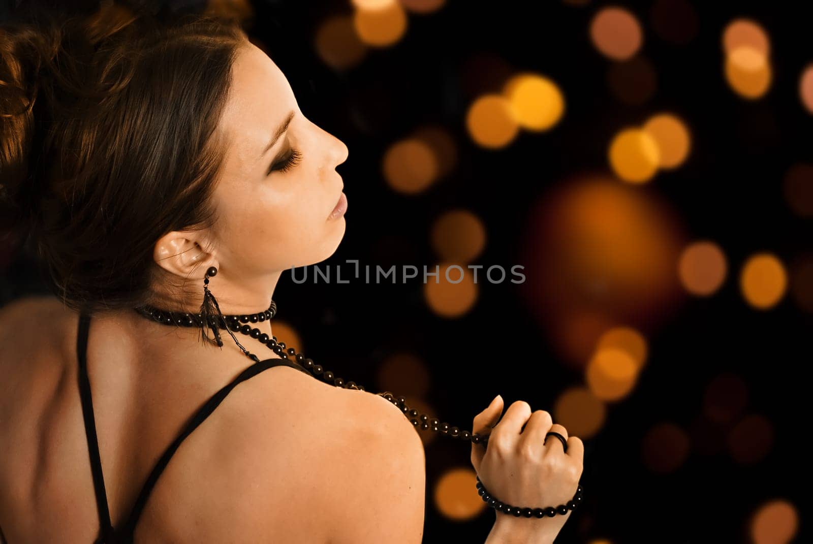Beautiful glamorous young woman in front of the night lights