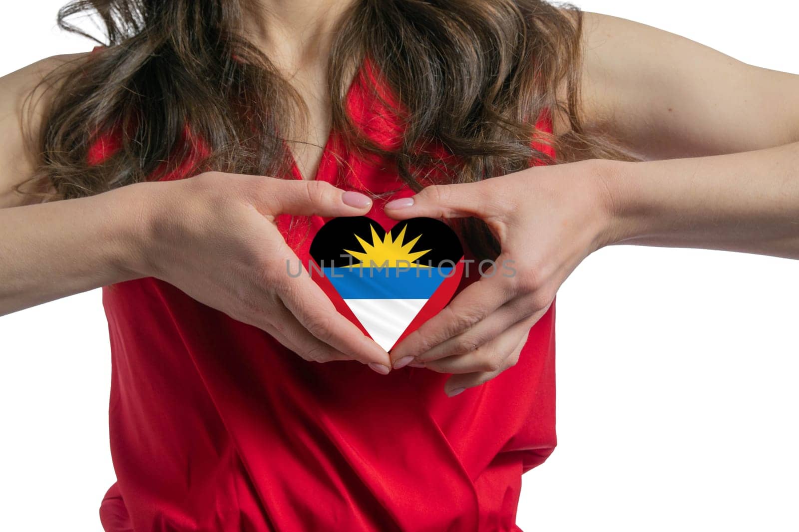 Love Antigua and Barbuda. The woman holds a heart in the form of the flag of Antigua and Barbuda on her chest. Concept of patriotism.