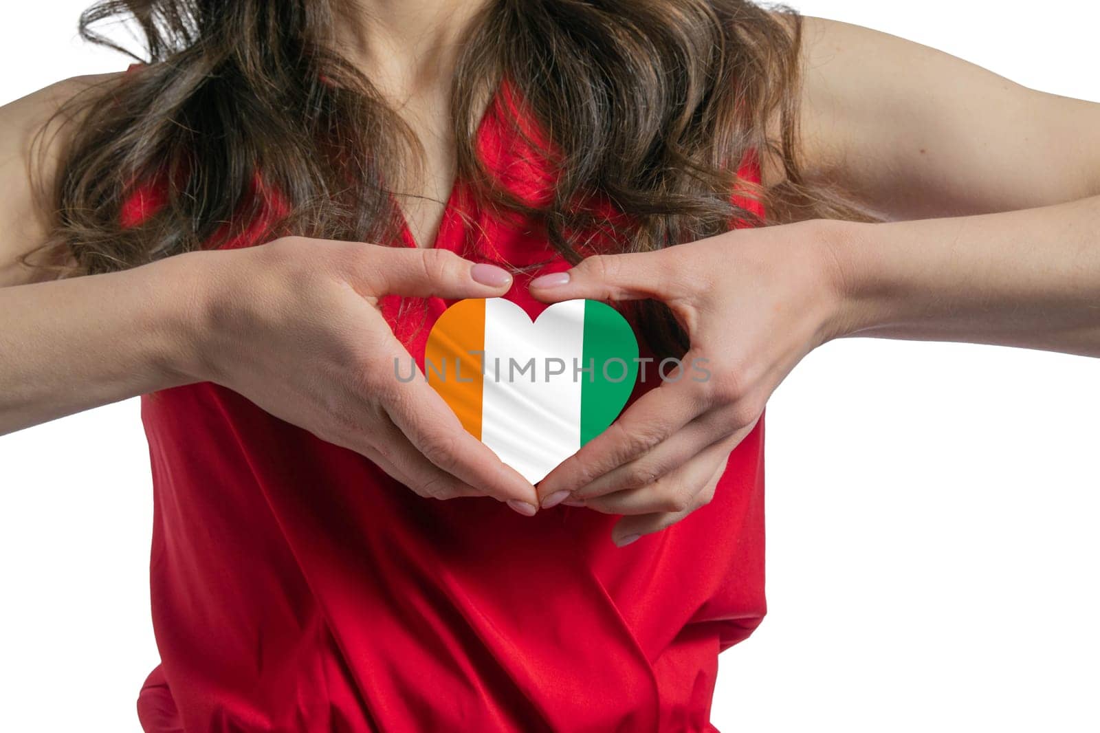 Love C te d'Ivoire The woman holds a heart in the form of the flag of C te d'Ivoire on her chest. Concept of patriotism.