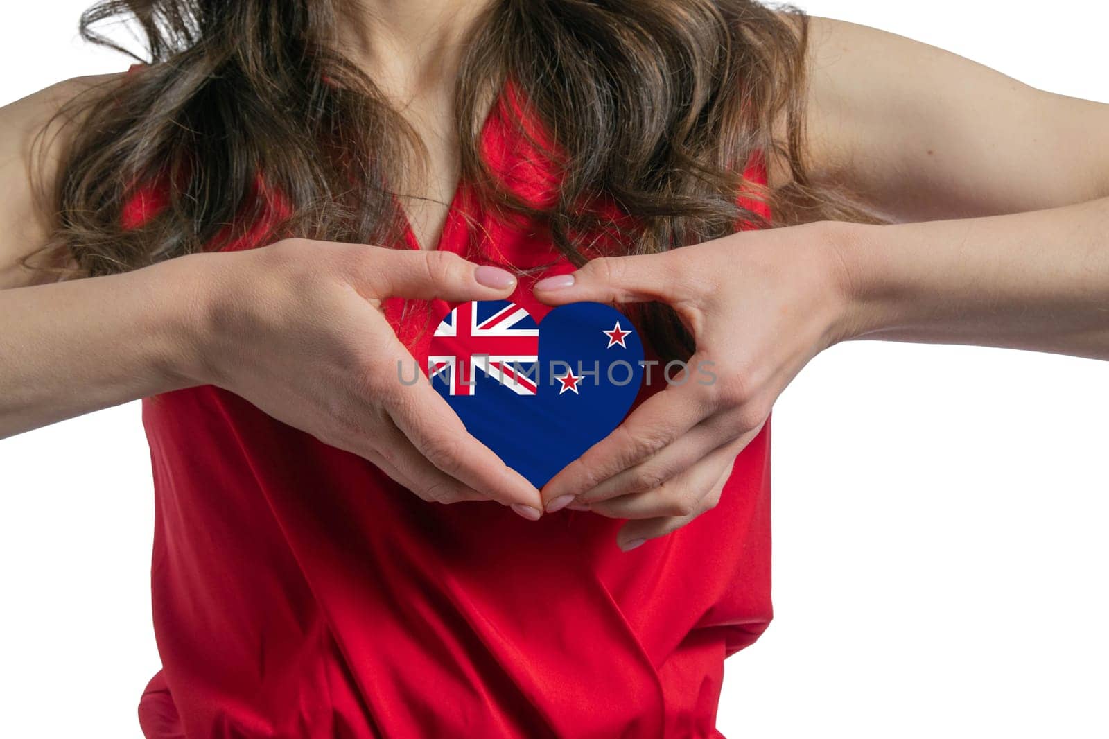 Love New Zealand. The woman holds a heart in the form of the flag of New Zealand on her chest. Concept of patriotism.