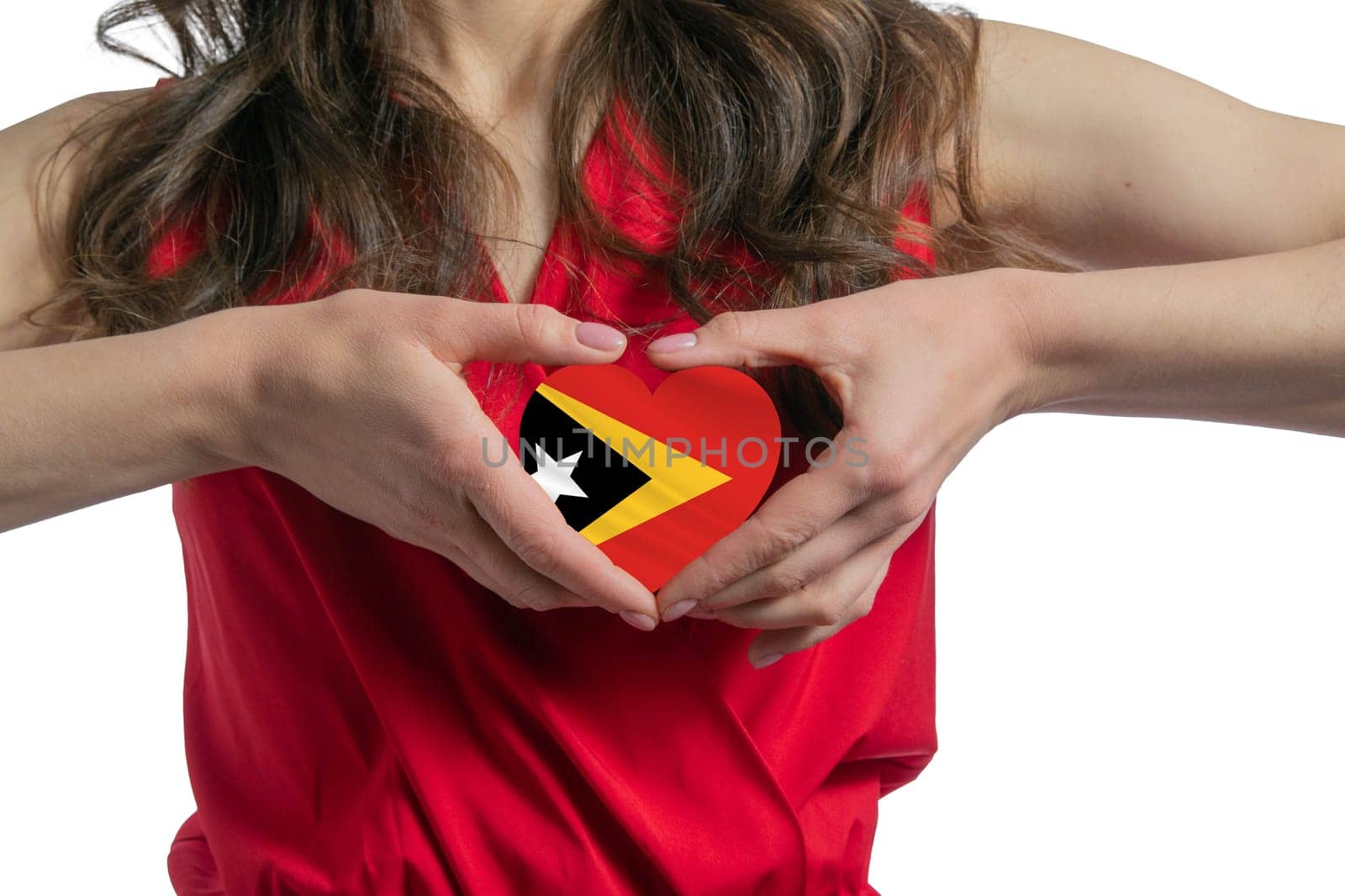 Love East Timor. The woman holds a heart in the form of the flag of East Timor on her chest. Concept of patriotism.