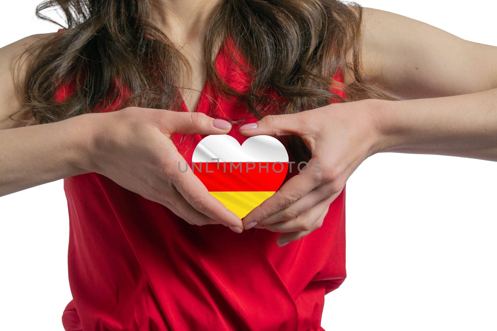 Love South Ossetia. The woman holds a heart in the form of the flag of South Ossetia on her chest. Concept of patriotism.