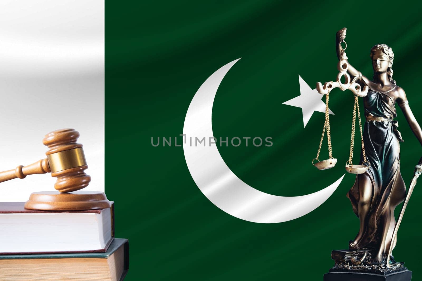 Law and justice in Pakistan. Statue of themis and the gavel of the judge against the background of the flag of Pakistan. Law and justice concept.