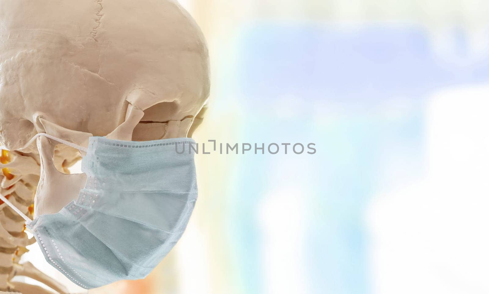 The Human skull in simple thin medical mask for protection against viral infection
