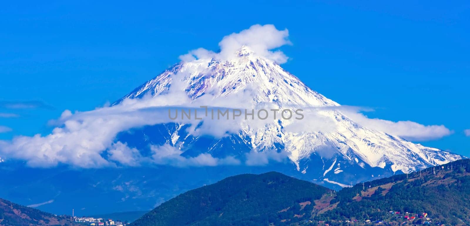Panoramic view of the city Petropavlovsk-Kamchatsky and volcanoes: Koryaksky Volcano, Avacha Volcano, Kozelsky Volcano. Russian Far East, Kamchatka Peninsula