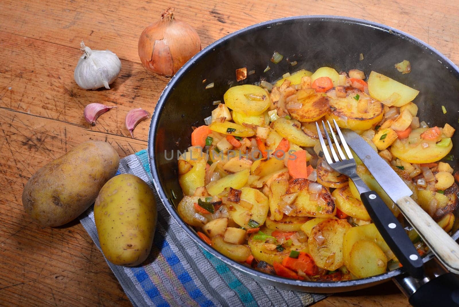 Roast potatoes in a black pan