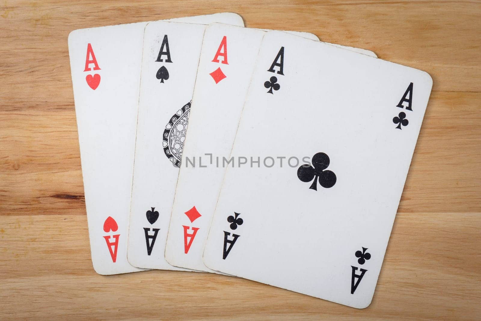 Poker black card on a wood background