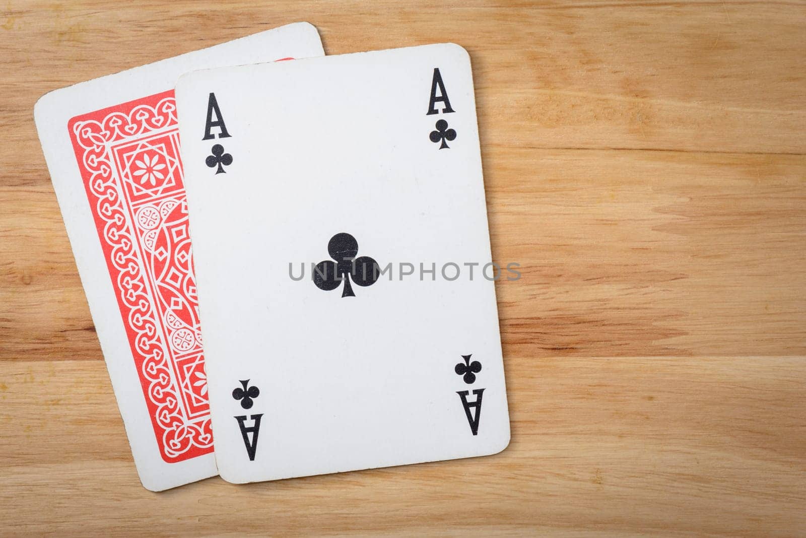 Ace and cover card on a wood background