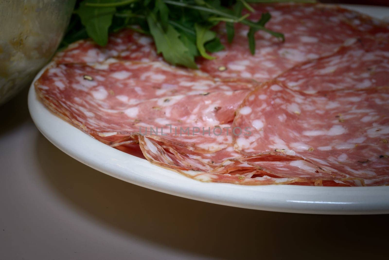 A Tipical Tuscany italian salami called finocchiona with rucola, tomato souce, mozzarella, tipical ingradients for italian pizza