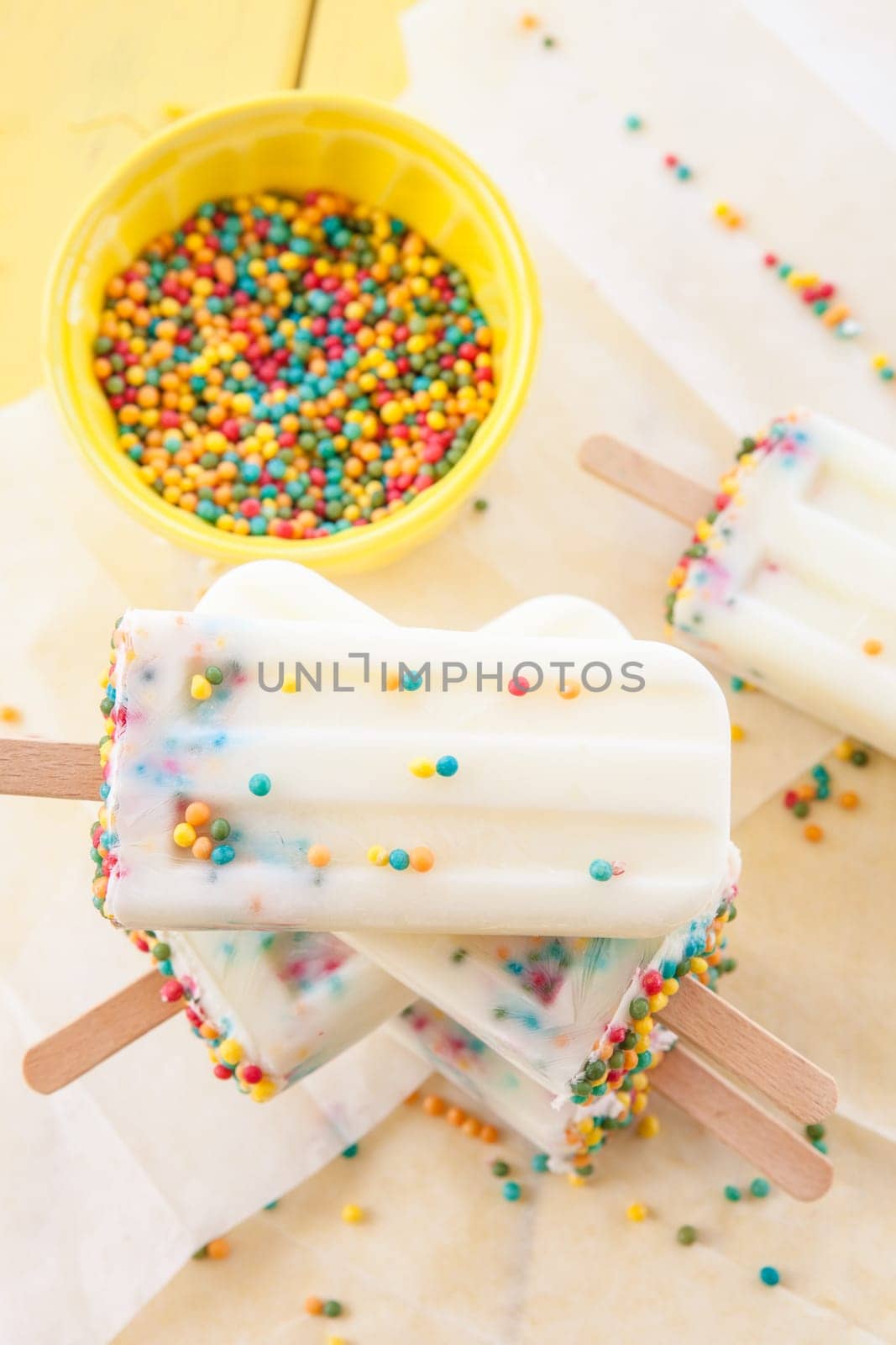 Homemade vanilla ice cream on the stem with colorful sprinkles
