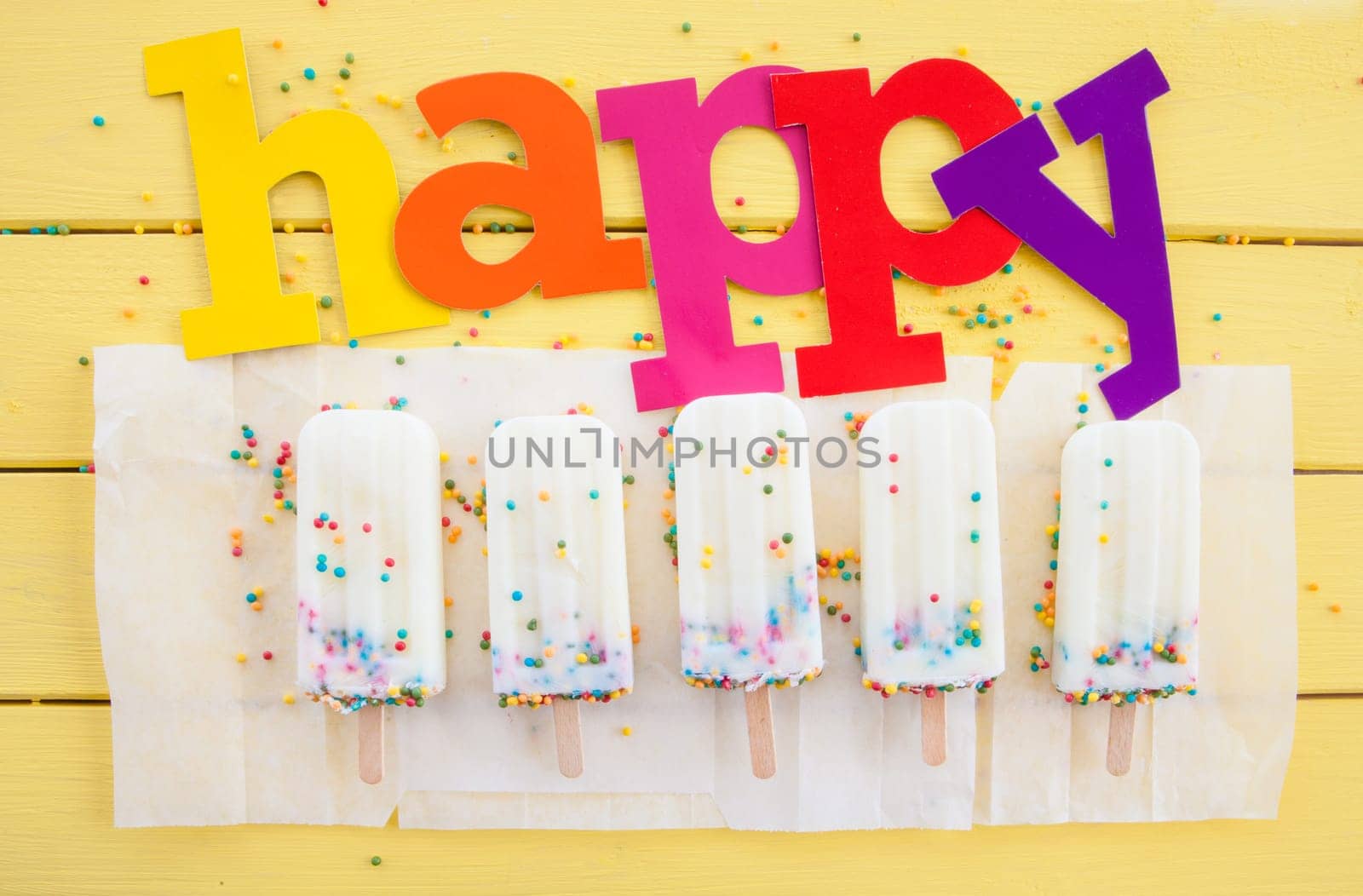 Homemade vanilla ice cream on the stem with colorful sprinkles