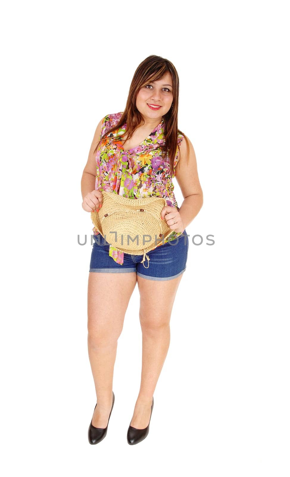 A young woman in jeans shorts and a straw hat standing,.isolated for white background..