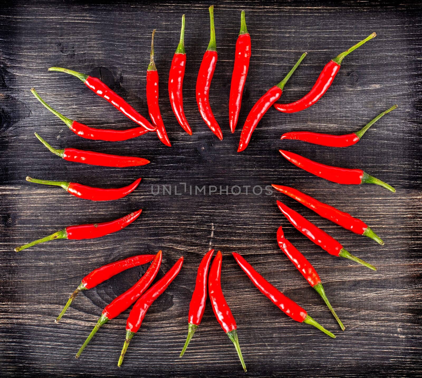 The top view of spicy red chili pepper on wooden surface. Selective focus