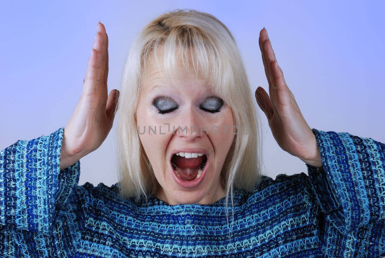 Young blonde woman with a cry