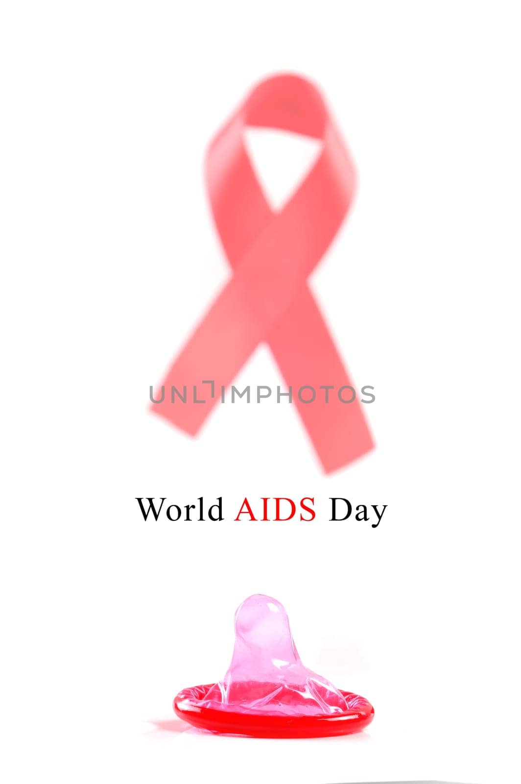 Aids ribbon and condom on white background.