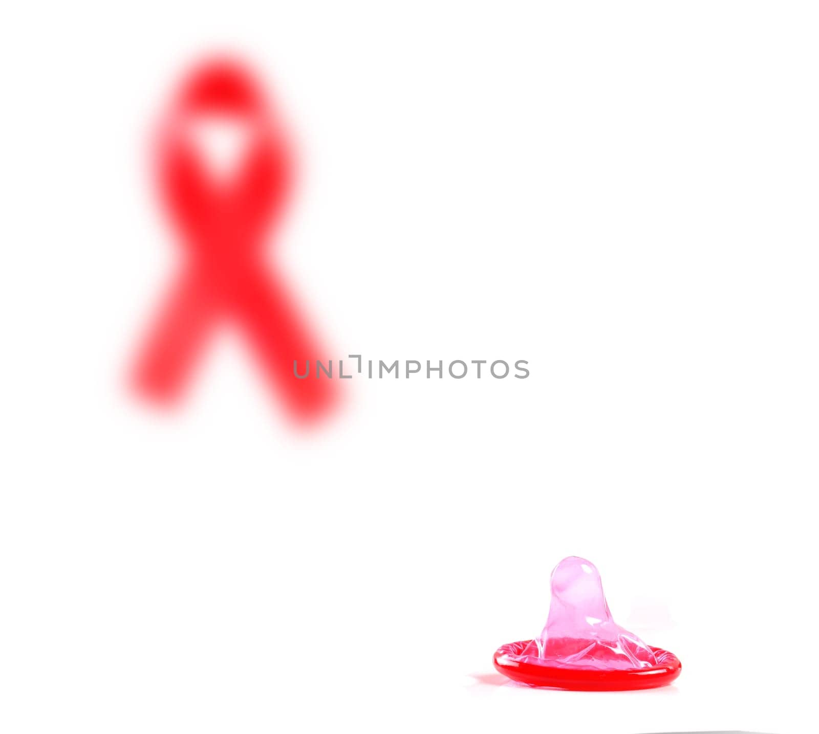 Aids ribbon and condom on white background.