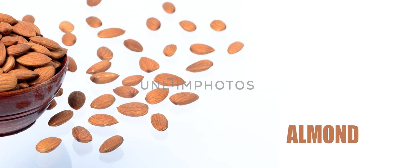 Almonds in a clay pot isolated on a white background