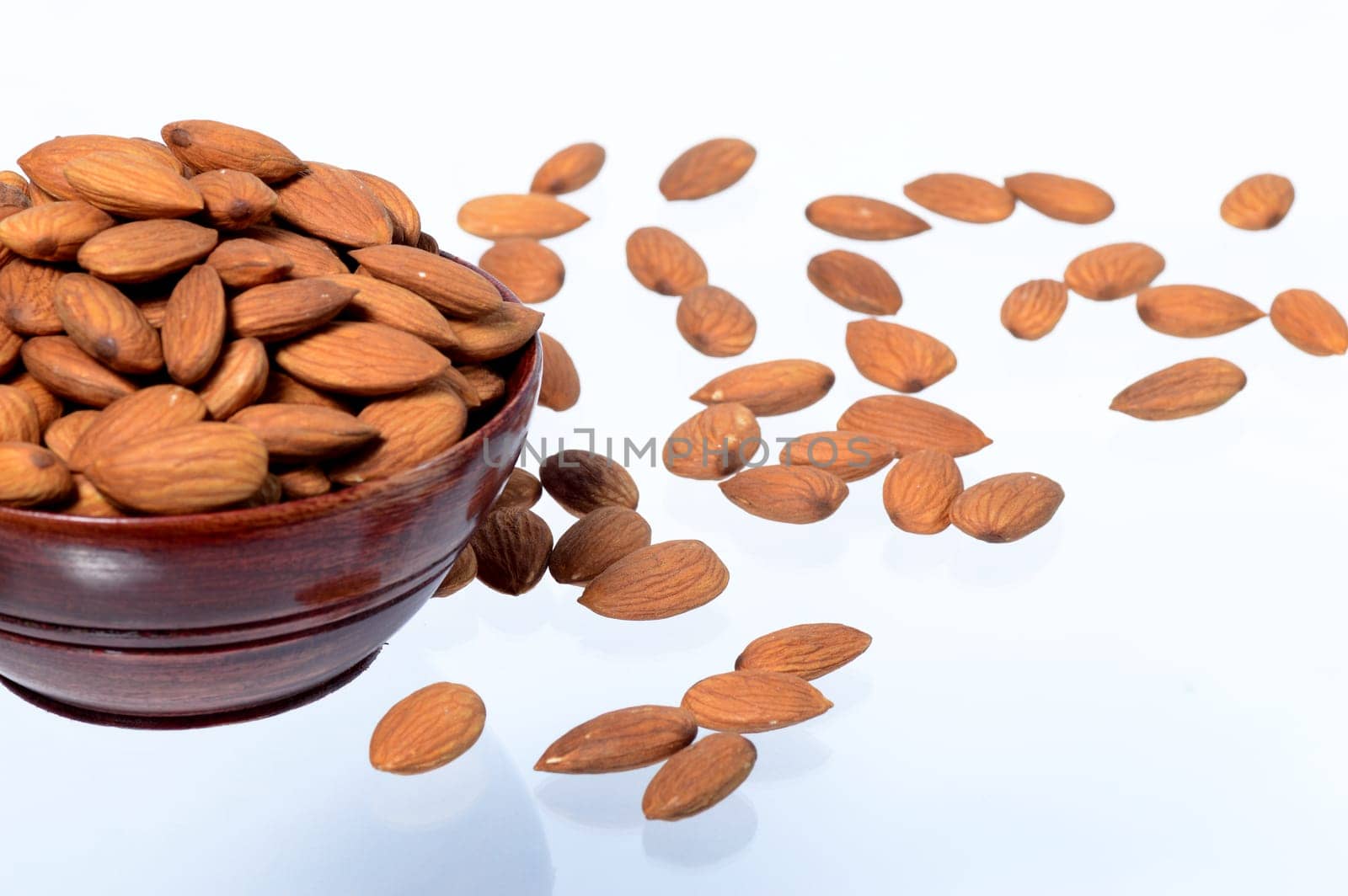 Almonds in a clay pot isolated on a white background