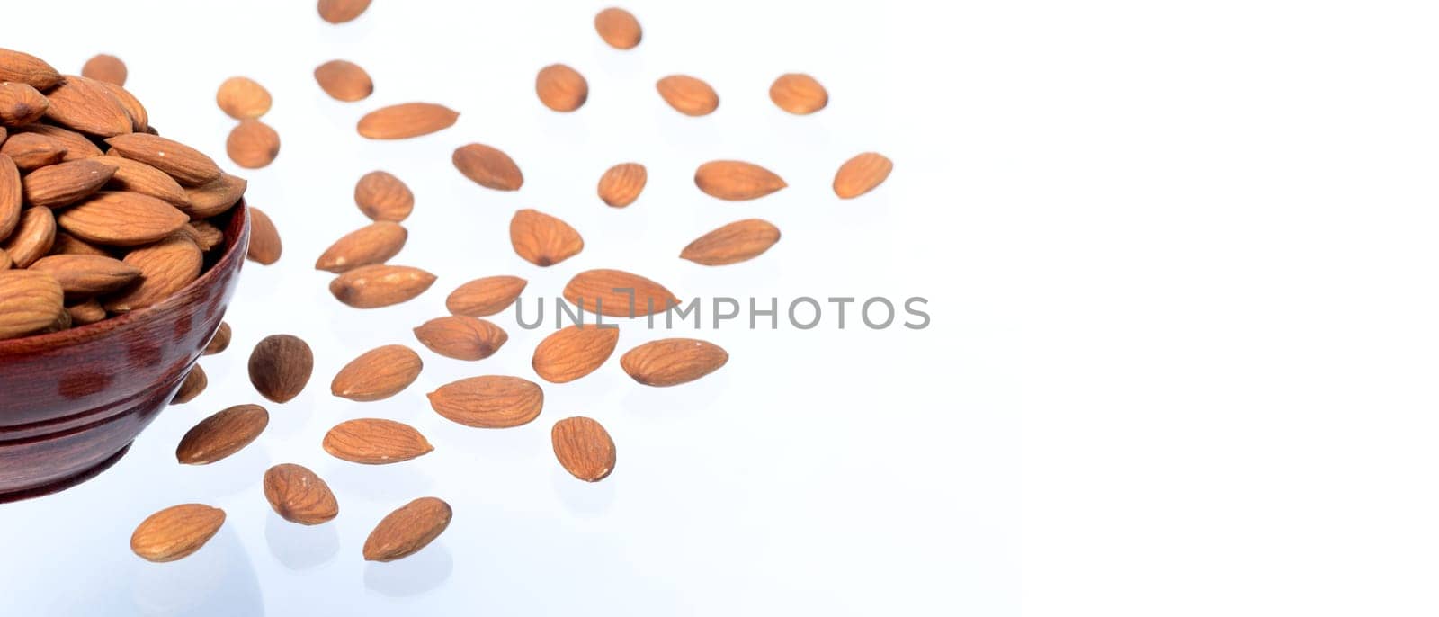 Almonds in a clay pot isolated on a white background
