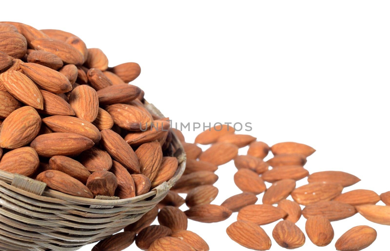 Almonds in a wooden basket with heap isolated on a white background