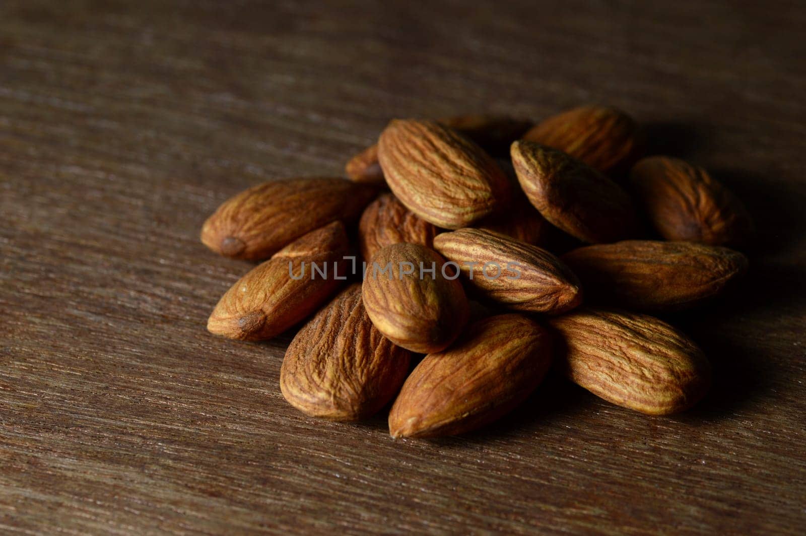 Tasty Almonds on a wooden background