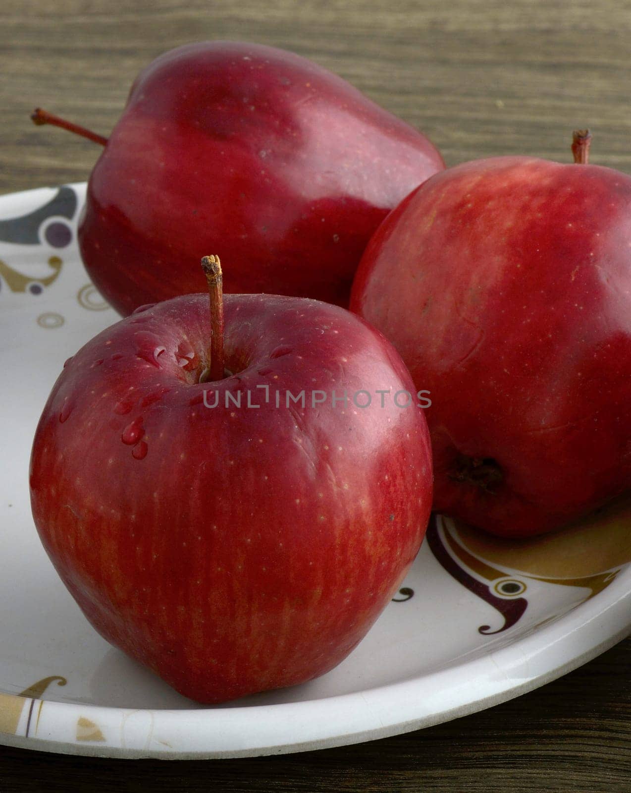Ripe red apples on wooden background