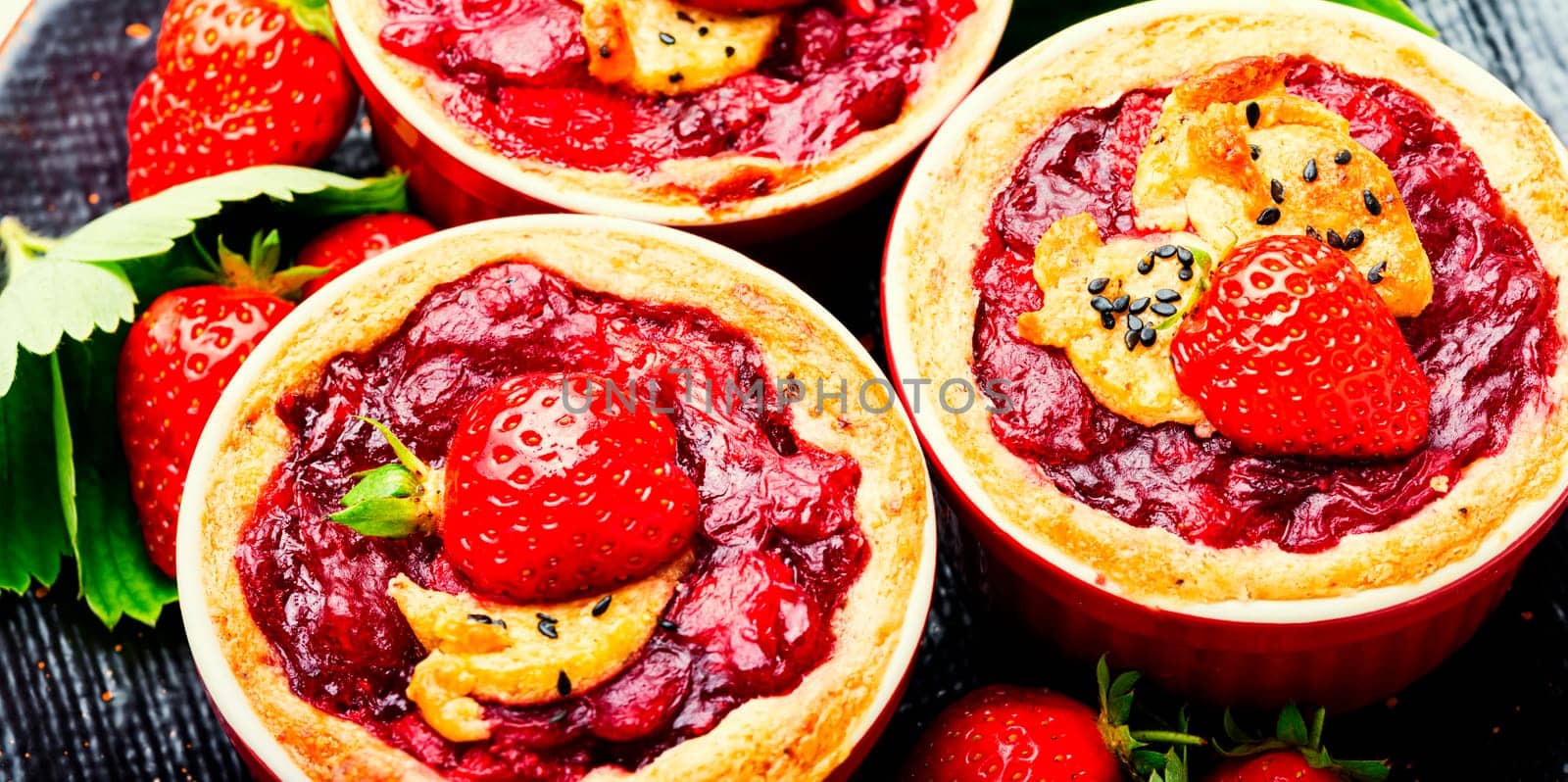 Strawberry shortcake pies on the plate.Tasty tartlets with fresh strawberries.Sweet dessert