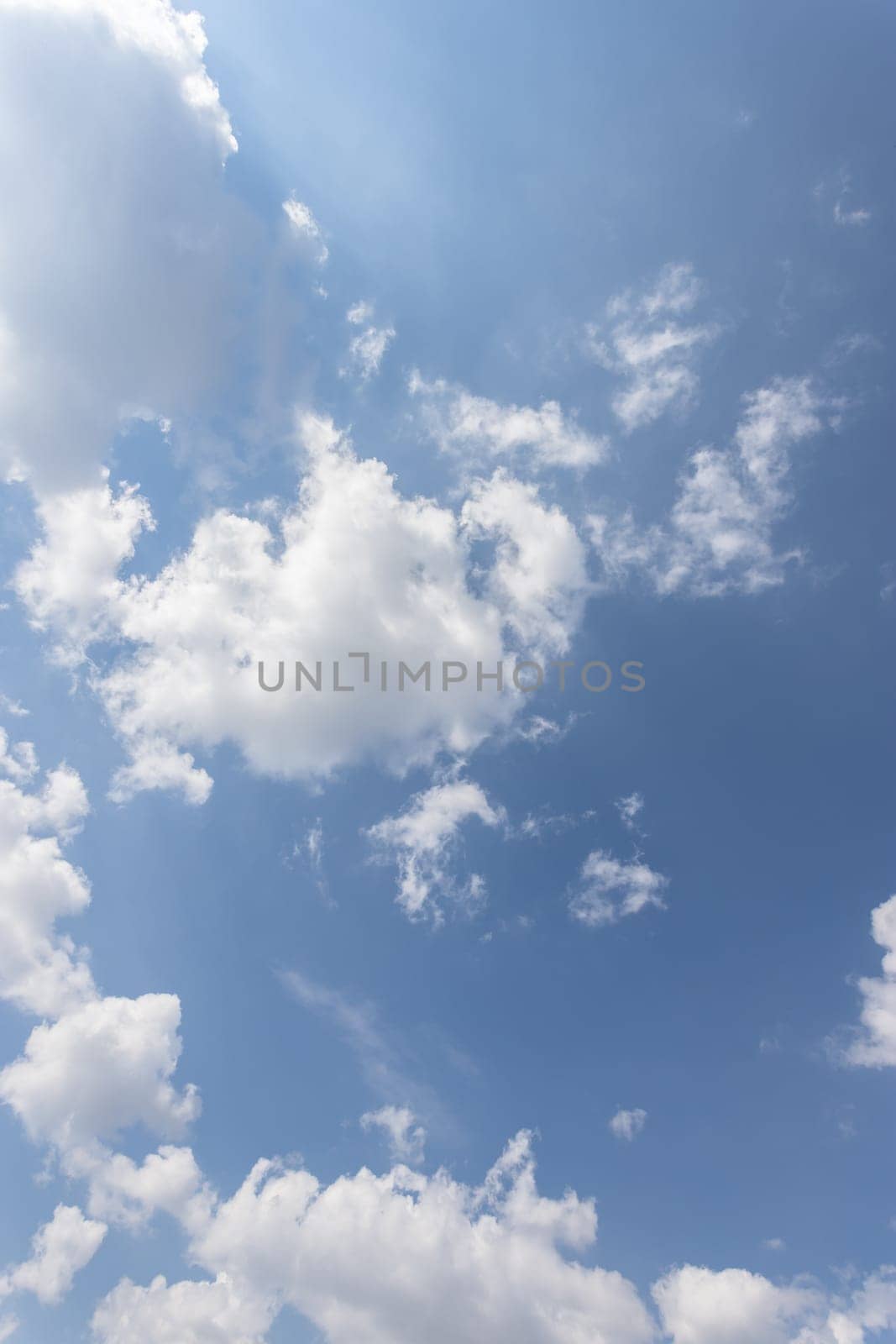 White and gray clouds with blue sky background.