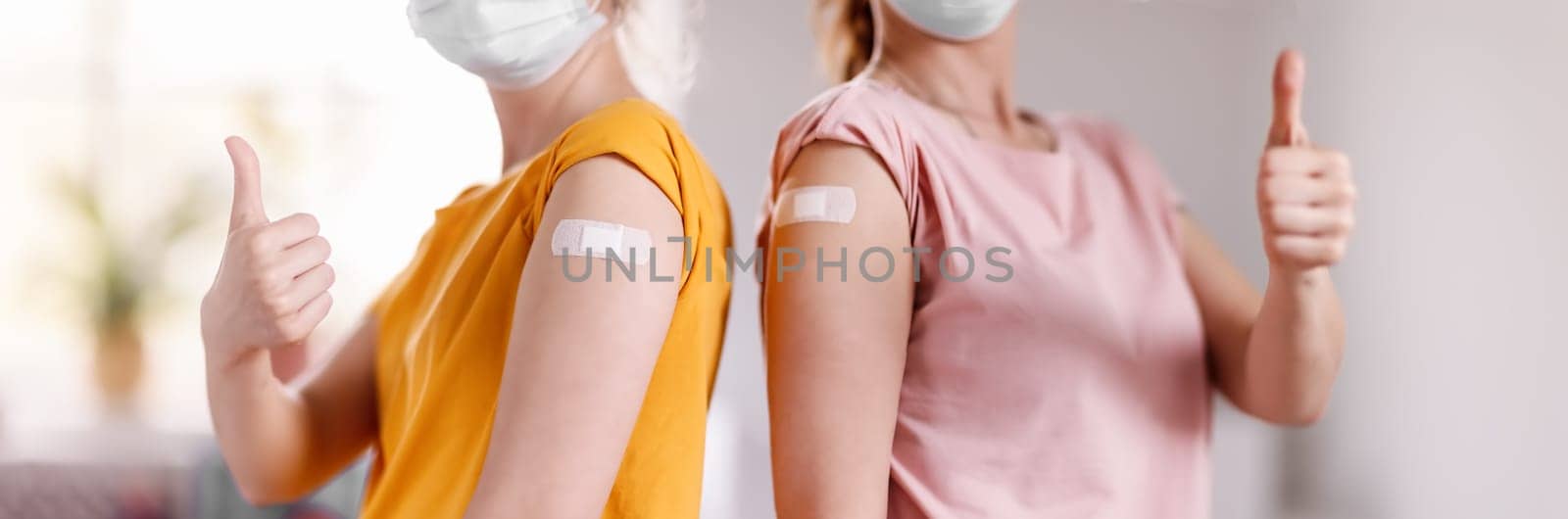Women showing thumbs up after inoculation against Covid 19. Concept of immunization and making injections from pandemic of SARS.