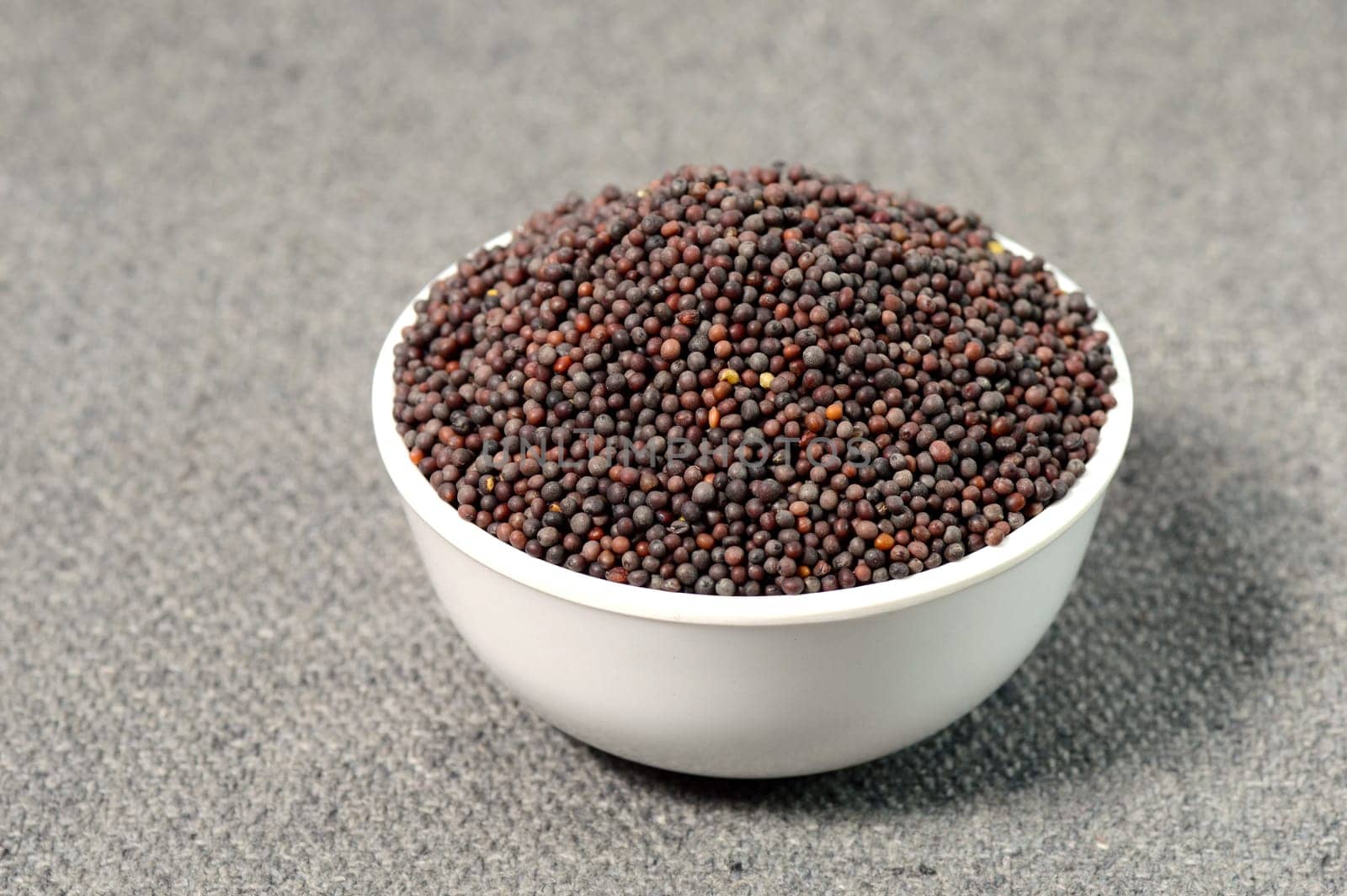 Brown Mustard Seeds in bowl on sackcloth