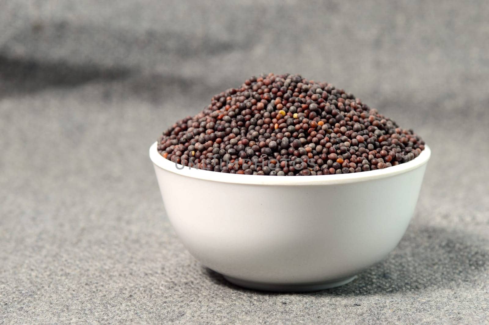 Brown Mustard Seeds in bowl on sackcloth