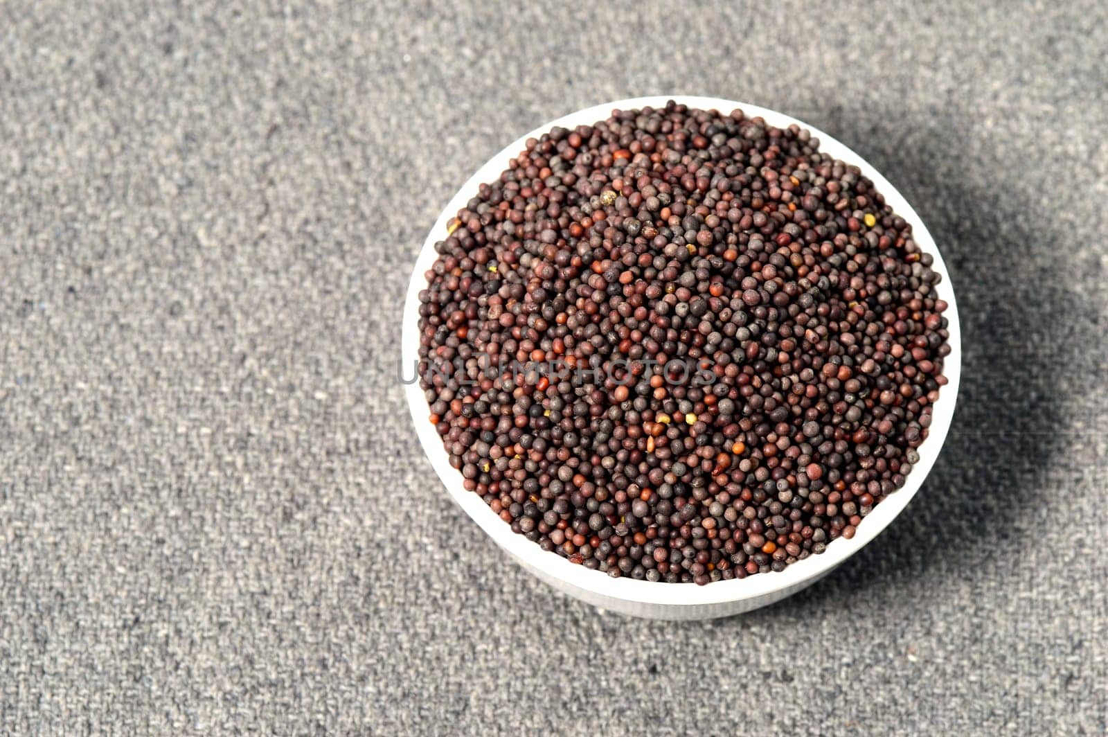 Brown Mustard Seeds in bowl on sackcloth